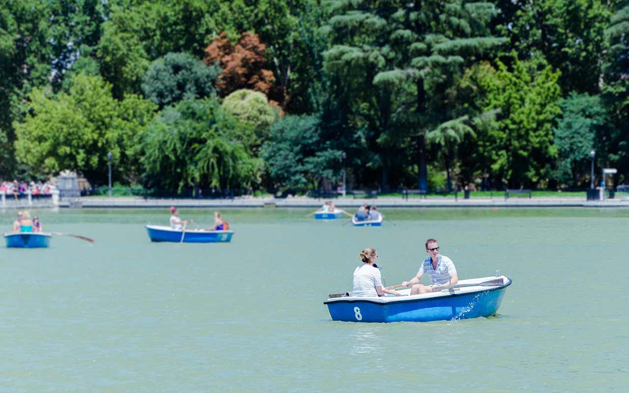 Tourists rowing a boat at El Retiro Park, Madrid