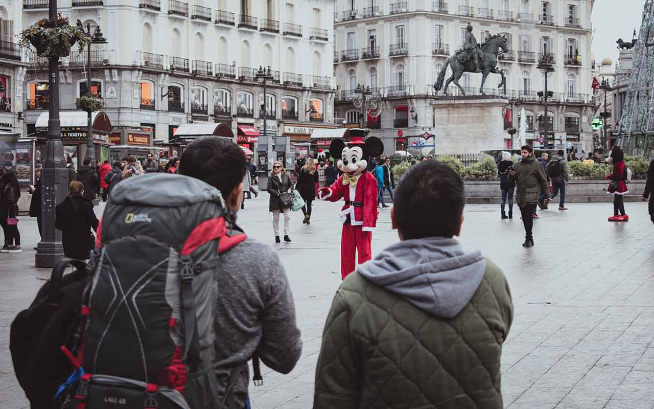 Backpackers touring Madrid practice safety by keeping their important items with them at all time