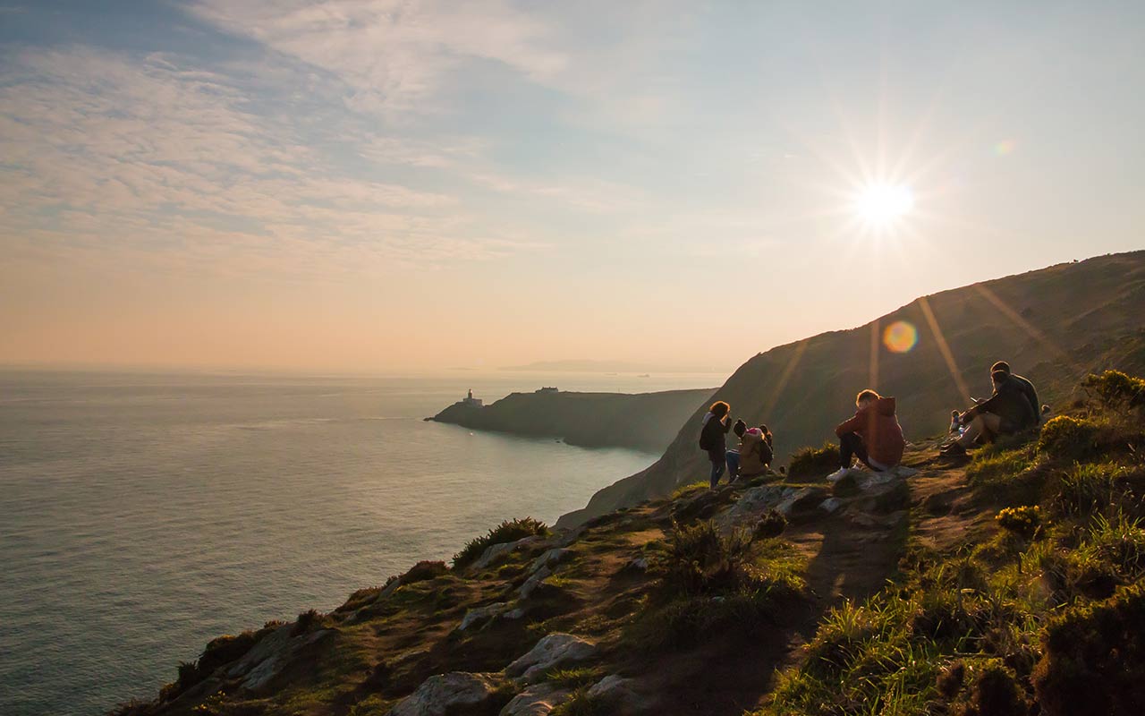 Hiking enthusiasts in the Howth Cliff surrounded by the green lush of Ireland