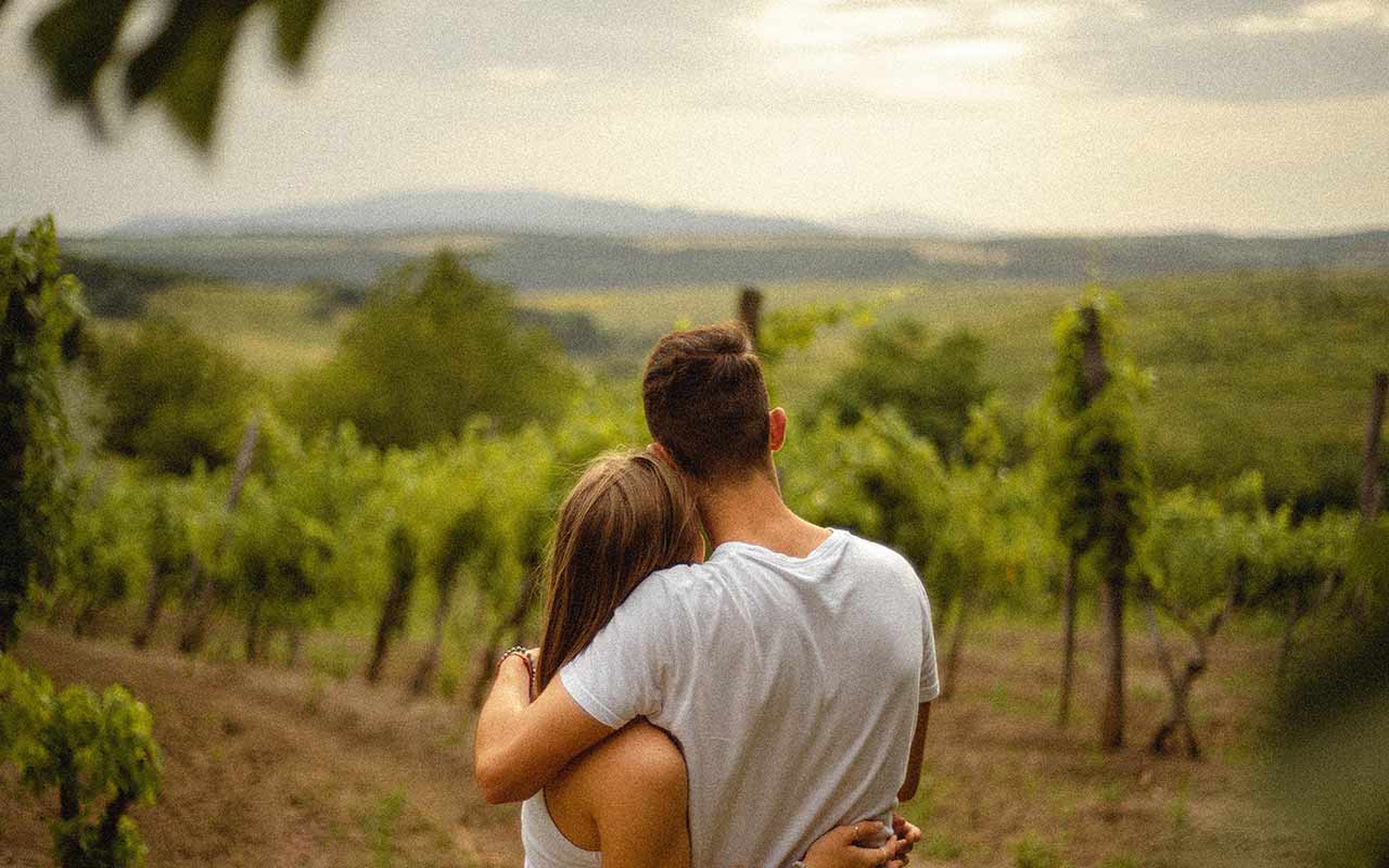 A couple looking beyond the vineyard in Eger, Hungary
