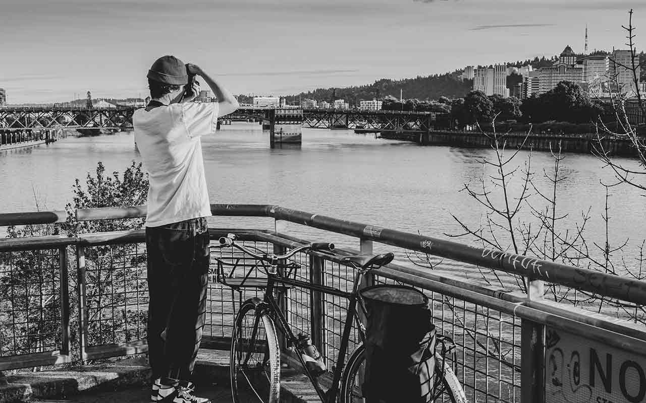 A tourist takes a photo of different views of Portland as he cycles through the city. 
