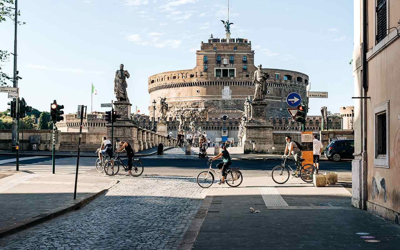 Tourists touring Rome by cycling during summer
