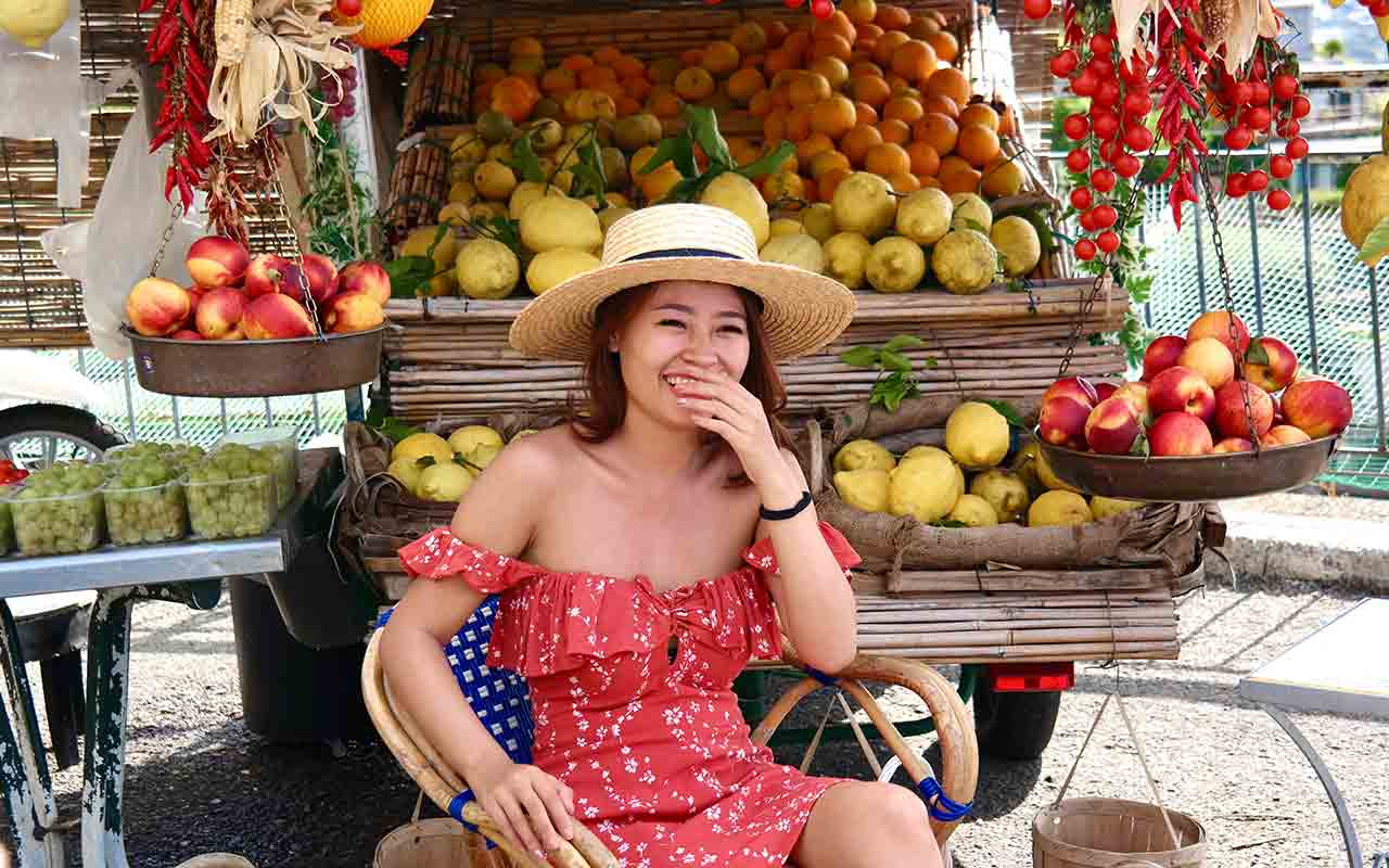 A woman surrounded by the citrus fruits that are available in the Amalfi coast