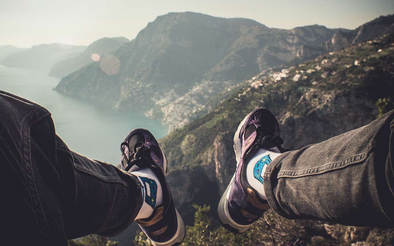 A hiker snaps a photo of his legs after reaching the trailhead of Path of Gods trail