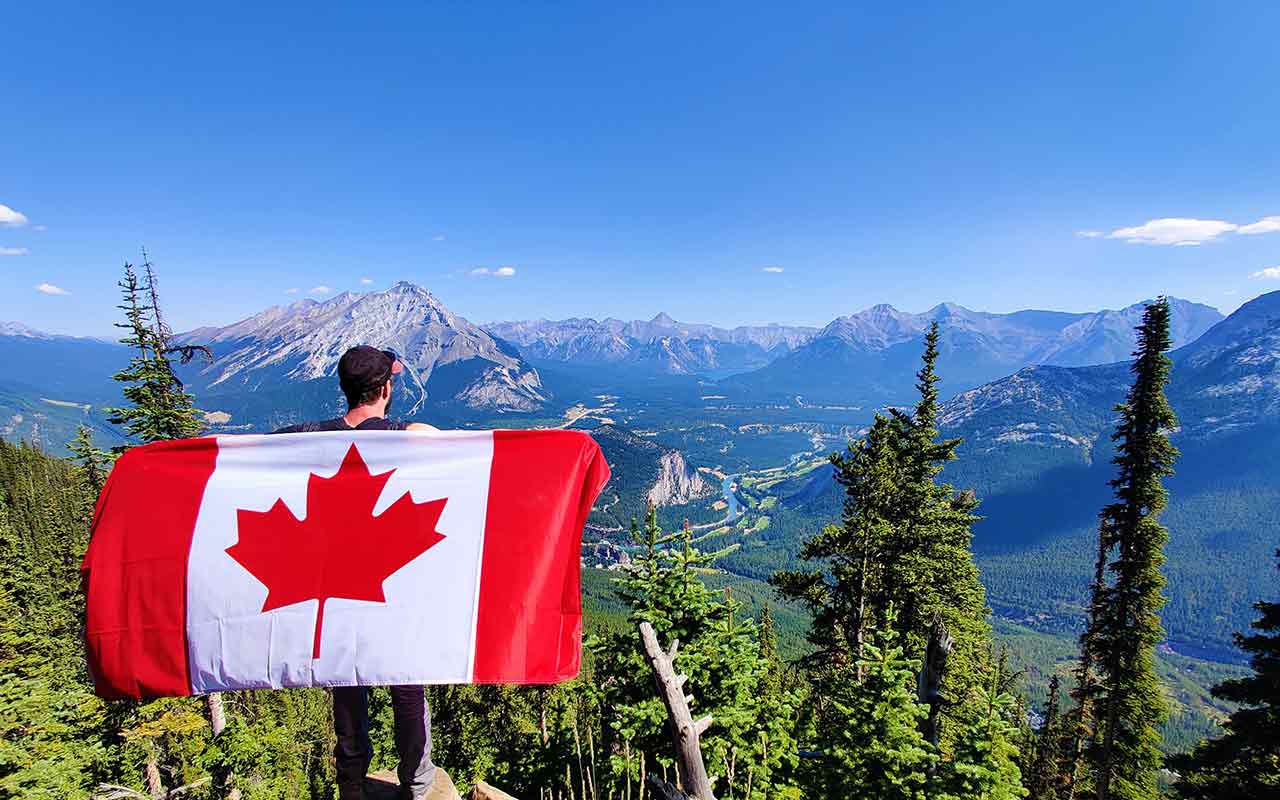 Welcome to Canada! A hiker overlooking a beautiful view in Canada