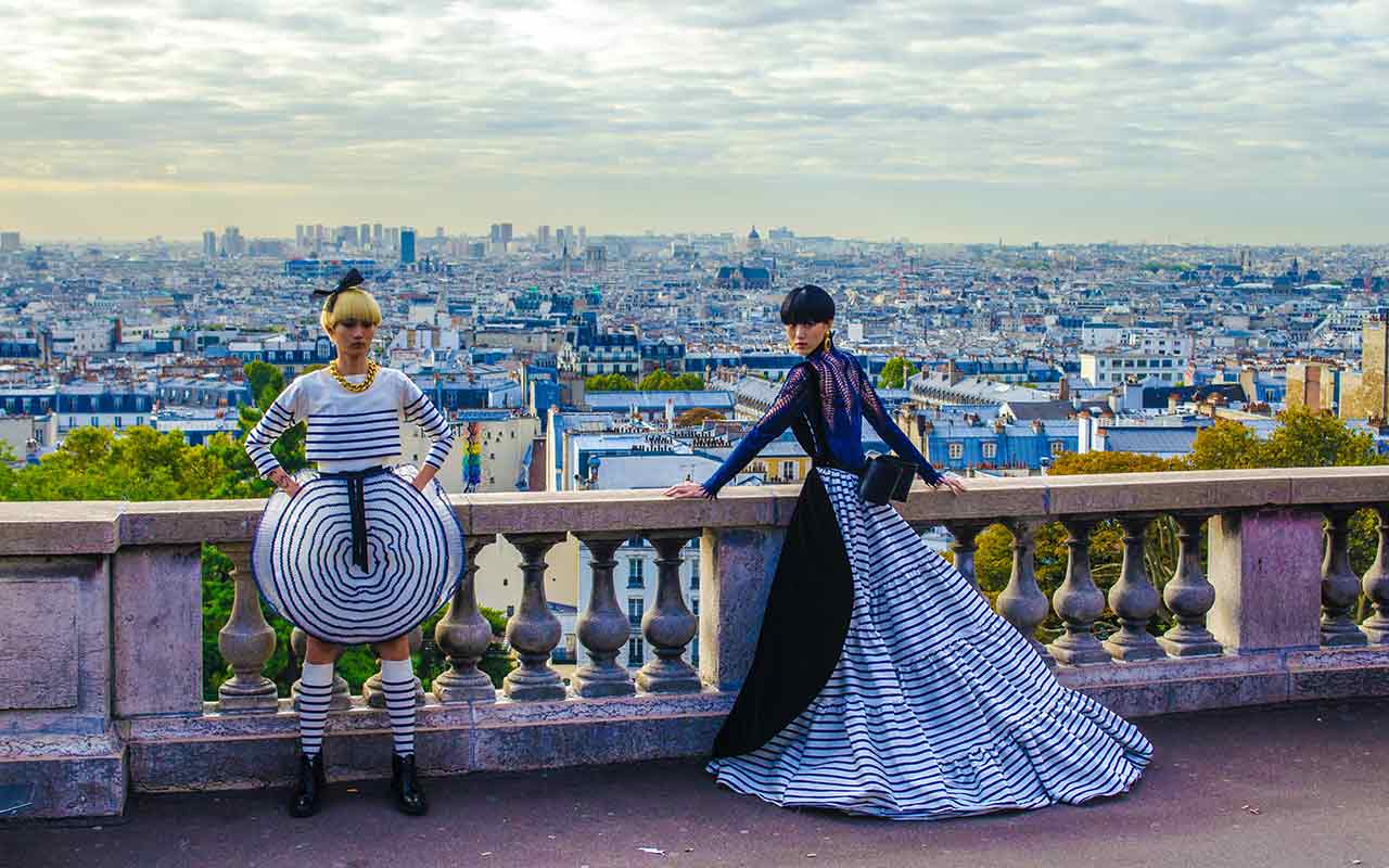 Two fashionable women taking photos at Paris, France