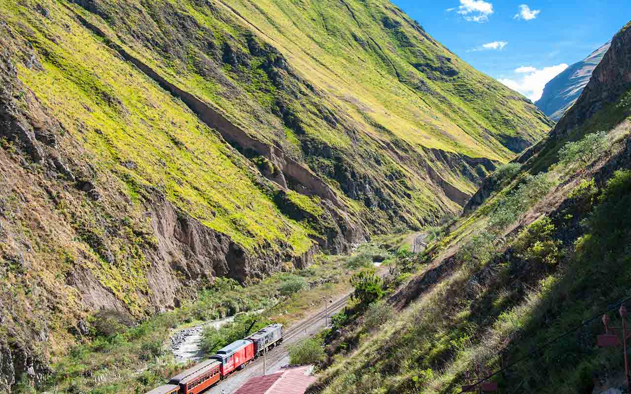 Train running through the Devil's Nose in the Andes mountains in Ecuador