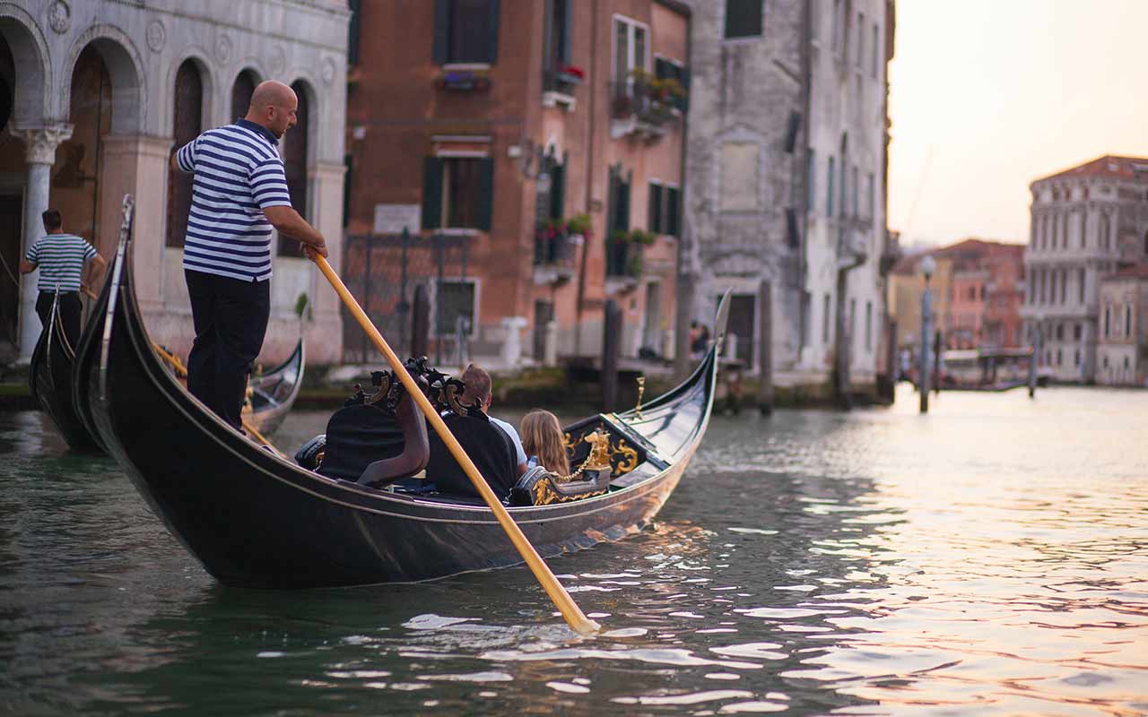 Tourists in a gondola ride in Venice